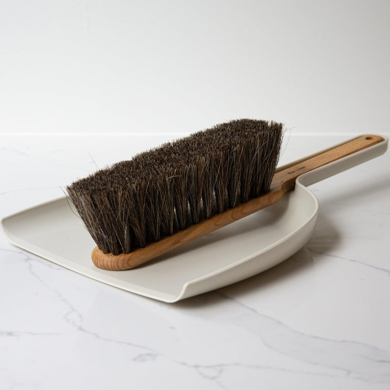 This versatile dustpan and brush set is perfect for any home, with a classic design that never goes out of style. Crafted from high-quality materials including oiltreated beechwood, horsehair, and bio-polyethylene, it's built to last and ideal for both indoor and outdoor use. With its sturdy construction, it makes sweeping and cleaning a breeze, providing reliable performance for years to come. Measuring approximately 15.25" L x 10" W x 4" H, it's the perfect size for any cleaning job.